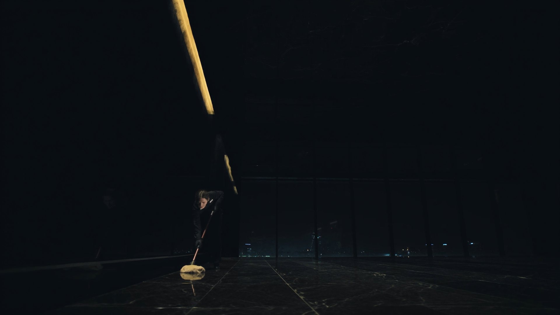 Night interior of a Charlotte office tower lobby being polished by a PyraClean cleaner